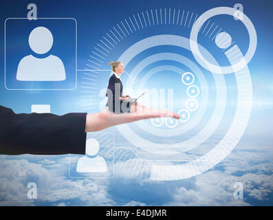Composite image of businesswoman using laptop Stock Photo