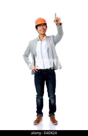 Full length portrait of asian engineer man point up isolated on white background Stock Photo