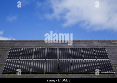 Rooftop solar panels under a blue sky. Stock Photo