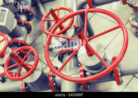 Red industrial valves on modern pipeline system Stock Photo