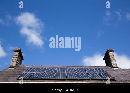 Rooftop solar panels under a blue sky. Stock Photo