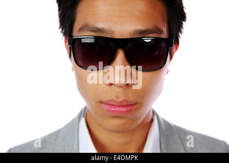 Closeup portrait of a serious asian man in sunglasses over white background Stock Photo