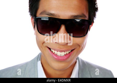 Closeup portrait of a happy asian man in sunglasses over white background Stock Photo
