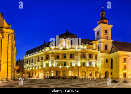 Twilight image with City Hall and Holy Trinity Roman-Catholic church in Sibiu. Large Square is center of medieval Historic city Stock Photo