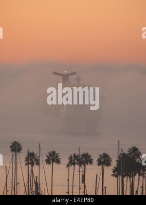 A cruise ship coming out of the mist very early in the morning at Long Beach cruise port, Los Angeles Stock Photo