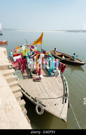 VARANASI, INDIA - MARCH 2014: People dries clothes on the deck of a boat at  the banks of Ganges River, Varanasi in March 2014. Stock Photo