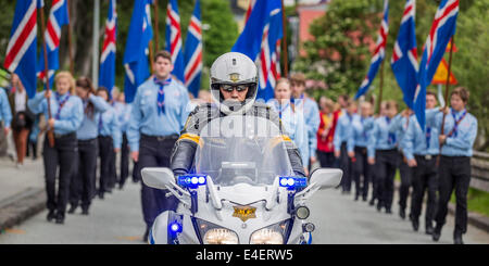 Scouts are being lead by a motorcade during a parade, celebrating Independence day, Reykjavik, Iceland Stock Photo