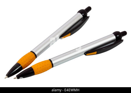 two orange, silver and black ballpoint pens on white Stock Photo