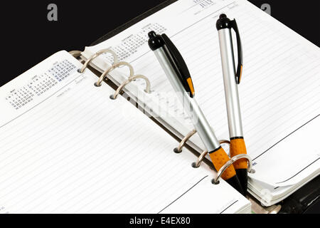 loose page diary in ring binder with two ballpoint pens Stock Photo