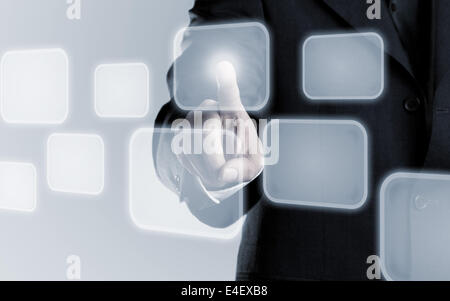 Businessman touching infogram graphics on virtual touchscreen with copy space Stock Photo