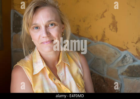 Portrait of mid aged female - A woman in her fourties looking friendly at the camera. Stock Photo
