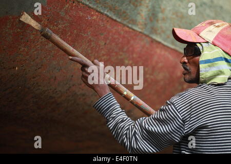 ship building yard,Adult,Asian Ethnicity,Bangladesh,Boat,Boatyard,Carrying On Head,Color Image,Construction,Dacca,Day,Developing Stock Photo