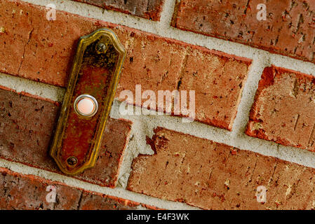 brass door bell on a brick wall Stock Photo