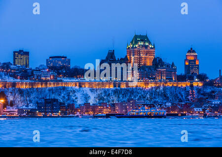 City skyline at twilight, showing Chateau Frontenac in winter, as seen from across the Saint Lawrence River, Quebec City Quebec, Stock Photo