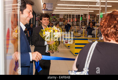 The first customer at a newly opened Lidl supermarket is presented with a bouquet of flowers by the manager, Puerto Santiago, Tenerife, Canary Islands, Spain. Stock Photo