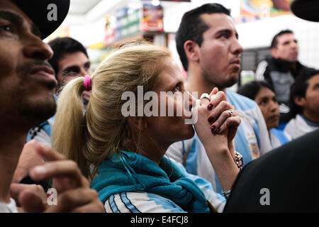 São Paulo, Brazil. 9th July, 2014. An Argentine fan in the middle of a crowd of fans watch the semifinal World Cup game between Argentina and the Netherlands outside a bar in the center of São Paulo, Brazil on July 9, 2014. Argentina won the game in the shootout by 4-2 and made to final. Credit:  Tiago M. Chiaravalloti/Pacific Press/Alamy Live News Stock Photo