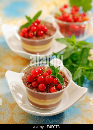 Chocolate mousse with apple and red currants. Recipe available. Stock Photo