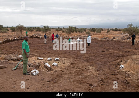 Men preparing simple helicopter landing site Amboseli National Park Kenya East Africa  PREPARING HELICOPTER LANDING SITE AMBOSEL Stock Photo