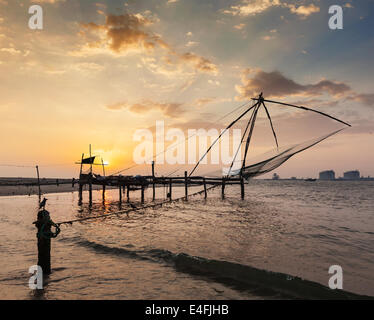 Kochi chinese fishnets on sunset. Fort Kochin, Kochi, Kerala, India Stock Photo