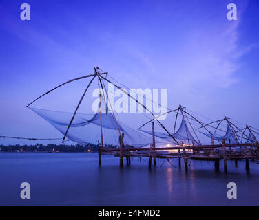 Kochi chinese fishnets on sunset. Fort Kochin, Kochi, Kerala, India Stock Photo