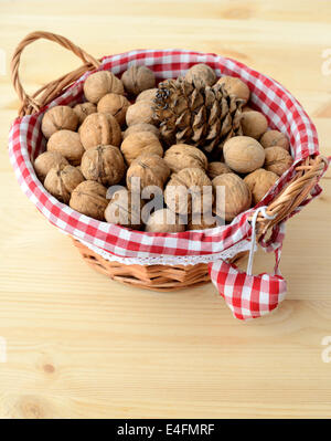 Basket with nuts on a wooden table. Stock Photo