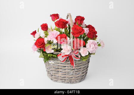 Beautiful pink carnations in basket isolated on white Stock Photo