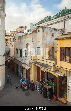 TANGIER, MOROCCO - MARCH 22, 2014: Street view of old Medina area in Tangier, Morocco. Ordinary people near small bread market Stock Photo