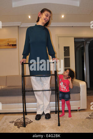 Karabuk, Turkey. 10th July, 2014. The world's tallest teenage girl Rumeysa Gelgi plays with her sister in Karabuk of Turkey, on July 10, 2014. 17 years old girl Rumeysa Gelgi who lives in Safranbolu district of Karabuk received the certificate of Guinness World Records as the world's tallest teenage girl with 2.13 meters standing length and 2.17 meters lying length on Thursday. The girl had Weaver syndrome which could lead to excessive growth of body. Sultan Kosen whose length 2.51 meters to the Guinness World Records as the world's tallest man also lives in Turkey. Credit:  Xinhua/Alamy Live  Stock Photo