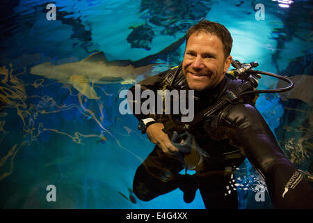 London, UK. 10th July, 2014.  As an ambassador for the Shark Trust’s No Limits? campaign, Steve Backshall takes the plunge with the sharks at SEA LIFE London Aquarium, demonstrating that their fearsome reputation is often misplaced and that focus should in fact be on the escalating scale of unmanaged shark fishing. www.sharktrust.org Credit:  Michael Kemp/Alamy Live News Stock Photo