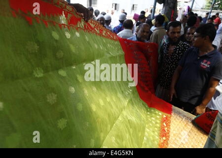 July 10, 2014 - Jamdani Sharee's hole sale market.A sharee is the traditional garment worn by women in the Indian subcontinent. It is a long strip of unstitched cloth, ranging from five to nine yards in length, which can be draped in various style. The most common style is for the sari to be wrapped around the waist, with one end then draped over the shoulder.The Sharee boasts of the oldest existence in the world. It is more than 5,000 years old! Some people think that sharee is influenced by Greek or Roman toga, which we see on ancient statues. Stock Photo