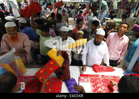 July 10, 2014 - Jamdani Sharee's hole sale market.A sharee is the traditional garment worn by women in the Indian subcontinent. It is a long strip of unstitched cloth, ranging from five to nine yards in length, which can be draped in various style. The most common style is for the sari to be wrapped around the waist, with one end then draped over the shoulder.The Sharee boasts of the oldest existence in the world. It is more than 5,000 years old! Some people think that sharee is influenced by Greek or Roman toga, which we see on ancient statues. Stock Photo