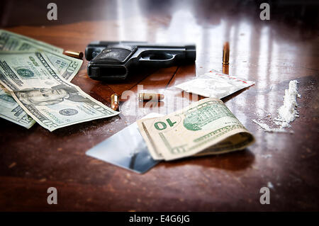 Cocaine, gun and lots of American money to represent an illegal drug transaction Stock Photo