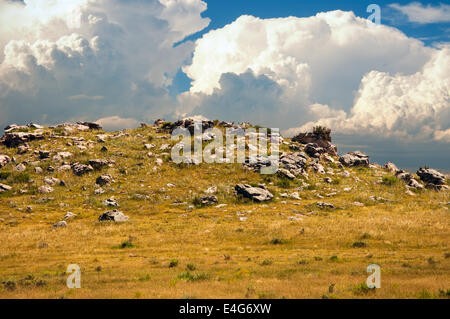 Storm clouds gathering over a rocky outcrop on section of Wyoming prairie Stock Photo