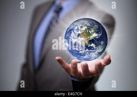 Businessman holding the world in his hands Stock Photo