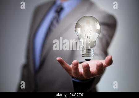 Business hand holding glowing light bulb against. 3d rendering Stock ...