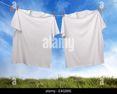 Blank white t-shirt hanging on clothesline Stock Photo