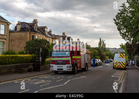 Bath, UK. 10th July 2014. Fire-fighters attend a fire at a late Victorian residential semi-detached house in Combe Park, Bath, just opposite the Royal United Hospital. The fire crew attended even though there was a public sector strike. Gas and Electricity workers were also on hand. Credit:  Paul Smith/Alamy Live News Stock Photo