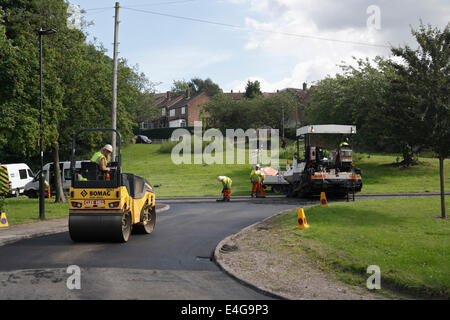 Road resurfacing work in a suburban street in Sheffield England. Men working road repairs Stock Photo