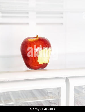 Closeup photo of big red bitten apple in the empty fridge, fruits diet, healthy lifestyle, organic nutrition, weight lost Stock Photo