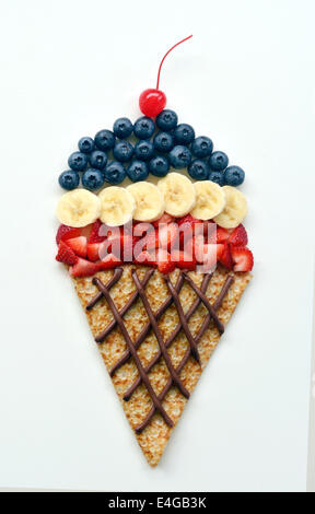 Food art of ice cream cone created with a crepe and fresh fruit Stock Photo