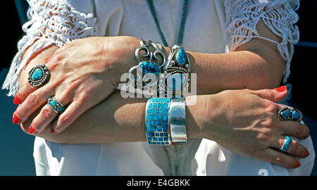 A woman displays her pawn jewelry collection of turquoise and silver rings and bracelets handcrafted by Navajo Indians in Arizona, USA. Stock Photo