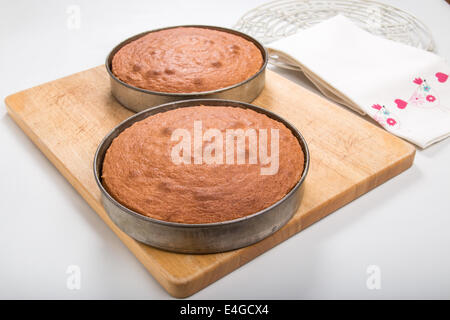 2 Victoria sponges in baking tin set on  wooden board  [Land] "making a cake" (  12of 44) Stock Photo