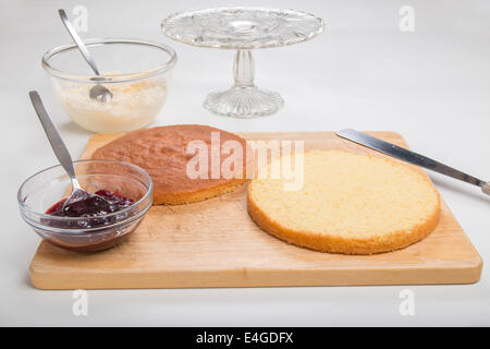 a victoria sponge cake sliced ready to add jam and butter cream  [Land] 'making a cake' (26 of 44) Stock Photo