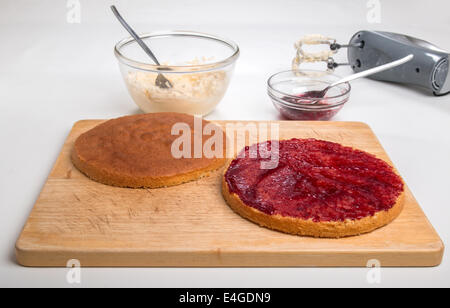 victoria sponge sliced, jam spread,ready for butter cream [Land] 'making a cake'  (27 of 44) Stock Photo