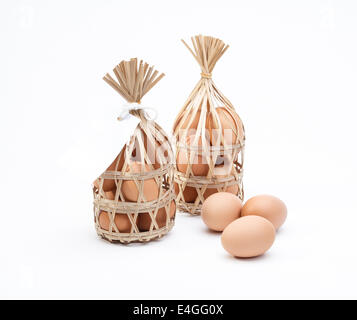 Organic eggs in bamboo baskets a healthy food gift isolated on white Stock Photo