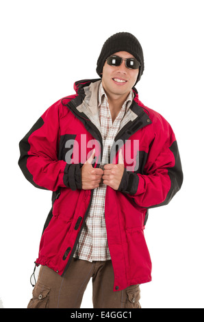 young man posing wearing red winter coat hat and sunglasses Stock Photo