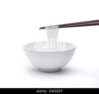 Ready made instant green pea noodle in a bowl with chopstick isolated on white background Stock Photo