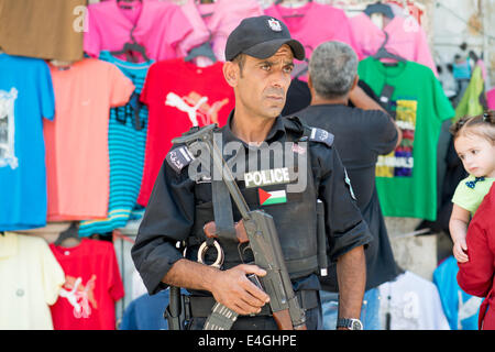 Ramallah. 10th July, 2014.  A police officer stands at his post in the commercial center of Al-Manara Square. Demonstrations have been flaring up in the area in reaction to the recent conflicts with Israel. Kevin Su/Alamy Live News