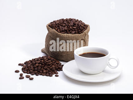 Coffee beans in bag and cup of coffee isolated on white background Stock Photo