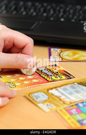 COQUITLAM, BC, CANADA - June 15, 2014 : Scratching lottery tickets. The British Columbia Lottery Corporation has provided govern Stock Photo